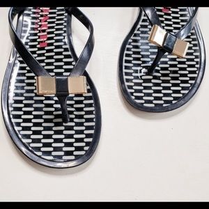 Coach “Landon” Gold Bow Black Jelly Flip Flops
